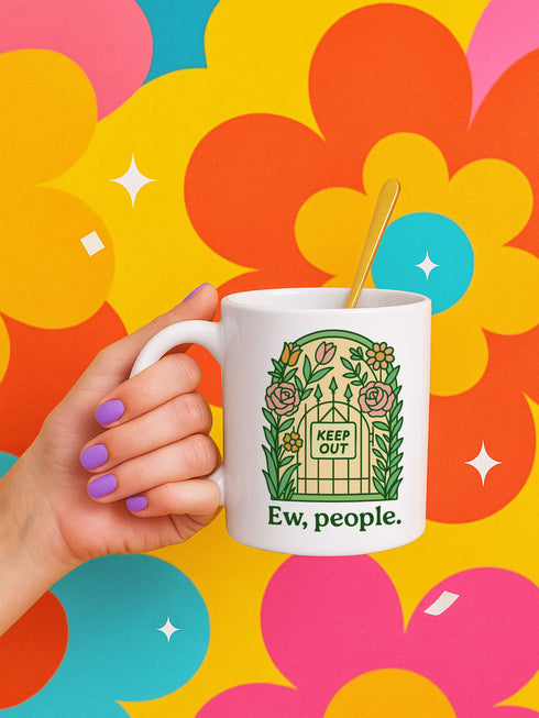 White ceramic coffee mug featuring "Ew, people" text beneath decorative garden gate design with "KEEP OUT" sign surrounded by roses and botanical florals. Perfect antisocial gift for introverts who prefer solitude over social interaction. 11oz ceramic cup ideal for coffee lovers, misanthropes, and homebodies who embrace their hermit lifestyle.
