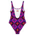 Bold patterned one-piece swimsuit with retro evil eye floral design, styled in festival-ready outdoor settings. Swimsuit features a scoop neckline, cheeky fit, and low scoop back. Ideal for summer vacations, pool parties, raves, and alt girl fashion. Made from stretchy, moisture-wicking fabric with UPF 50+ protection. Available in sizes XS to 3X. Colorful, statement swimwear designed for confident, maximalist style lovers.