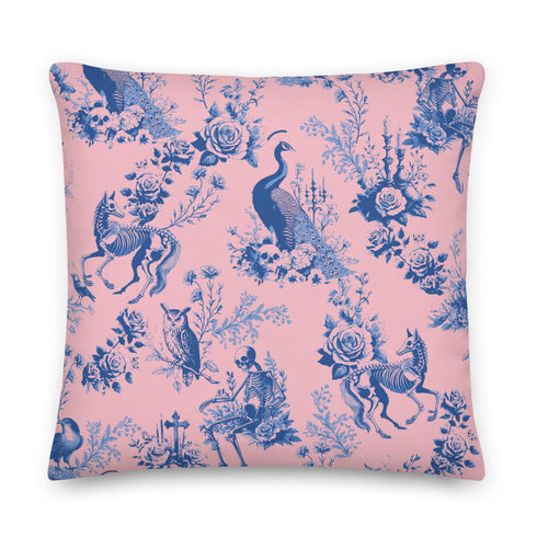 Luxury throw pillow cover featuring a gothic toile pattern in deep blue on a soft pink background, with skeletal figures, peacocks, and floral motifs.