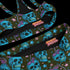 High-waisted bikini set featuring an all-over pattern of neon blue skulls with pink bows, pastel stars, and purple cherries on a dark olive green background. The top has a scoop neckline with wide straps, and the bottoms offer full coverage. A bold, punk-inspired swim look perfect for alternative fashion lovers and dopamine dressers.