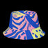 Reversible bucket hat with a bold all-over psychedelic tiger stripe print in pink, blue, yellow, and black; made of moisture-wicking polyester with a linen-texture feel; available in sizes XS, S/M, and L/XL; features two different sides with unique patterns.