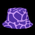 Reversible unisex bucket hat featuring two distinct designs - one side showcases a vibrant floral pop art pattern with purple, pink, green and blue splashes and organic flower motifs, while the reverse side displays a purple giraffe print pattern with dark purple giraffe spots on a light purple background. Made from 100% polyester with textured linen feel, this moisture-wicking and breathable hat is available in XS, S/M, and L/XL sizes for ultimate style versatility.