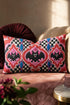Rectangular 20x12 inch lumbar pillow cover in red featuring printed faux embroidery of three black bats with white eyes and pink noses, each framed in an ornate ogee medallion with pink flame stitch centers, black and white checkerboard accents, and cobalt blue diamonds. Whimsigoth damask bat design printed on both sides with a hidden zipper, crafted from soft linen look polyester for spooky maximalist home decor.