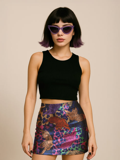 High-waisted fitted mini skirt featuring a vibrant tiger print in rainbow colors over a blue and purple camouflage background. The skirt includes a 1.5” elastic waistband and is made of eco polyester and spandex. Pencil fit hugs the body with a smooth silhouette. Available in performance or glitter finish, sizes S to XL.