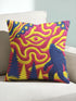 A square decorative throw pillow cover featuring a trippy retro Bigfoot scene. A large navy blue silhouette of Sasquatch walks through a forest of navy and yellow pine trees. The background is a psychedelic swirling sky in vibrant pink and yellow, featuring a large stylized eye and a cluster of small yellow stars. The flat two dimensional print visually mimics the textured look of heavy needlepoint embroidery. The pillow features a sleek hidden zipper on the bottom. No insert is included.