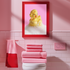 A fine art print of a glamorous rubber duck styled like Marilyn Monroe, with short curled blonde hair and soap bubbles. Displayed in a gold ornate frame against a pink wall with orange bead curtains.