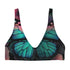 Scoop-neck bikini top with wide straps and a gothic butterfly wing design in deep jewel tones—teal, burgundy, and violet—set against black. Sports-bra style silhouette with bold symmetrical wing details across the chest. Floating above a turquoise pool, this swim top serves dreamy alt-girl energy for pool witches, celestial babes, and butterfly goths alike.