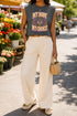 A garment dyed charcoal grey women's muscle tee featuring a slightly cropped boxy fit with structured shoulders and a wide rib collar. The front displays a retro 70s psychedelic graphic printed in purple, orange, and yellow. The text reads MY BODY MY CHOICE surrounding a central eye motif with a radial sunburst, framed by symmetrical mystical swirls and four point stars. The vintage style cotton shirt offers a faded aesthetic, presented on its own without background lifestyle elements.