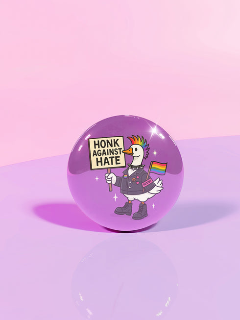Purple pinback button featuring cartoon goose with rainbow mohawk wearing black military-style jacket with resistance patches and combat boots, holding "Honk Against Hate" protest sign and rainbow pride flag, set against purple background with stars, designed for activism and LGBTQ solidarity support