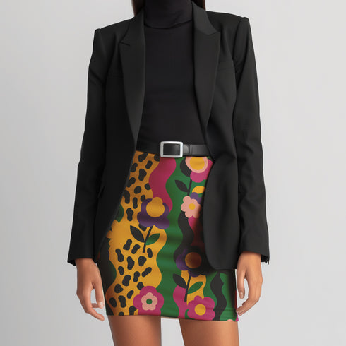 A woman wearing a black blazer and a colorful skirt with a floral pattern.