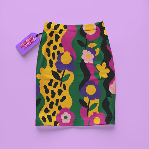 A colorful floral skirt with a leopard print pattern is displayed against a purple background.
