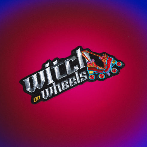 Embroidered patch featuring 'Witch on Wheels' text in metallic silver and white. Colorful roller skate design with vibrant rainbow hues. Fun, retro-inspired accessory for skaters and witchy enthusiasts. Ideal for jackets or bags.