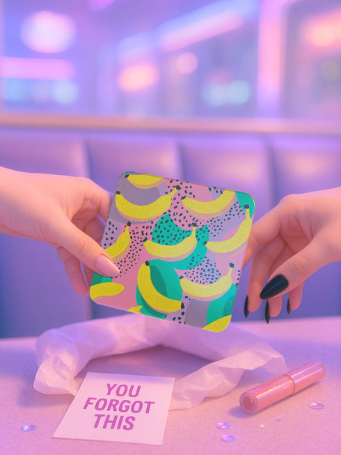 Square drink coaster featuring a playful banana print with bold yellow bananas over a pastel pink, purple, and green abstract background. Made of durable hardboard MDF with a cork backing and a glossy protective topcoat. Measures 3.74 by 3.74 inches, water-repellent and heat-resistant. Perfect for fruit-themed, retro, Y2K, coquette, or dopamine-core decor styles.