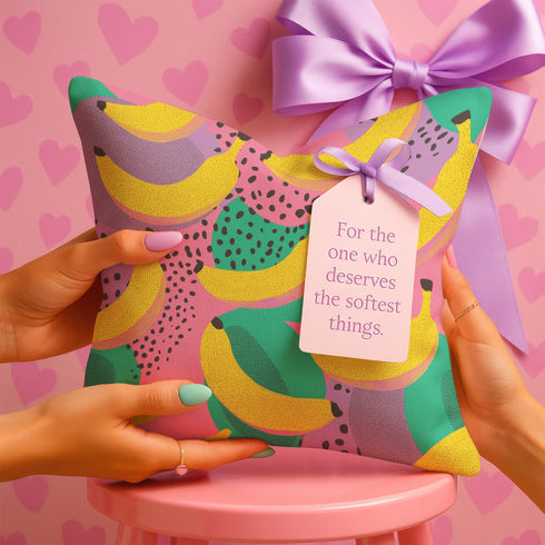 Colorful square pillow cover featuring a bold banana print in yellow, pink, green, purple, and black. The print appears on both sides and is made of luxe polyester with a linen-like texture. Hidden zipper closure. Available in two sizes: 22x22 inches and 18x18 inches. Designed for bright, dopamine-style, maximalist home decor.