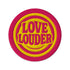 A round, 3-inch embroidered Love Louder patch designed with a vibrant, retro 70s aesthetic. The design features groovy, puffy-style text in a bright, sunny yellow thread, set against a bold magenta pink twill fabric background. The words 'LOVE LOUDER' are stacked to fill the center, encircled by concentric yellow rings that create a hypnotic, radiating effect. The entire circular patch is finished with a clean, durable merrowed border.
