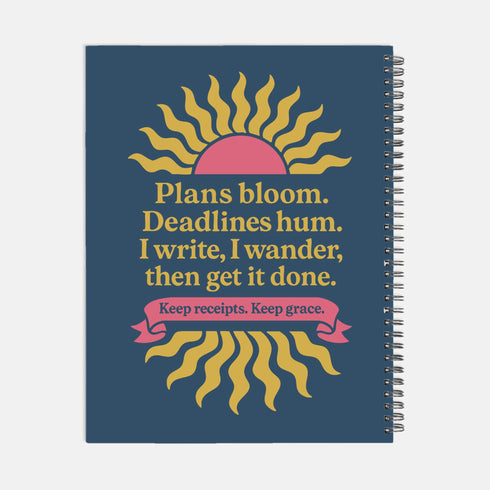 A hardcover spiral planner for 2026 with a dark blue cover and retro 70s style graphics. The title reads "2026 SHITSHOW All-Seeing Agenda" in bold yellow and pink text. Below the title is a large, stylized all-seeing eye with pink rays emanating from it. At the bottom, a pink ribbon contains the text "BLINK TWICE FOR MERCY." The back cover is also dark blue with a yellow sun graphic and the text "Plans bloom. Deadlines hum. I write, I wander, then get it done. Keep receipts. Keep grace.