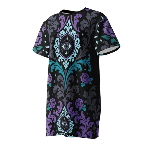 Cotton t-shirt dressA short-sleeve structured t-shirt dress with a black background. The dress features a bold, vertically stacked repeating graphic print. The design includes intricate damask patterns in teal and grey, purple roses with teal leaves, and a central evil eye motif set inside an ornate frame with small four-point stars. The heavyweight fabric holds a clean, straight cut above the knee with zero drape, maintaining a sculptural, slightly boxy silhouette.