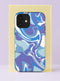 Front view of a dual layer tough phone case printed edge to edge with a liquid marble swirl in cool tones. Flowing ribbons of periwinkle, lavender, sky blue, cobalt, and bright white twist and fold across the case in a smooth psychedelic pour, like ink dropped in water. No hard lines, just calm movement in shades of blue and purple. Dreamy pastel marble phone accessory for blue mood days, with open ports and a precise camera cutout.