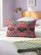 Rectangular 20x12 inch lumbar pillow cover in red featuring printed faux embroidery of three black bats with white eyes and pink noses, each framed in an ornate ogee medallion with pink flame stitch centers, black and white checkerboard accents, and cobalt blue diamonds. Whimsigoth damask bat design printed on both sides with a hidden zipper, crafted from soft linen look polyester for spooky maximalist home decor.