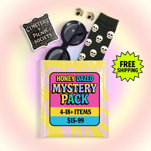 A curated alternative style bundle from Honey Dazed, available as a mystery box gift for her. This aesthetic grab bag is personalized to a chosen vibe, such as goth and pretty, psychedelic groovy, maximalist mayhem, alt skater gremlin, or weirdcore. Each surprise pack contains a high-value assortment of unique items like women's apparel, accessories, jumbo stickers, enamel pins, patches, and alternative home decor. Perfect as a birthday gift, a personalized care package, or a surprise box.