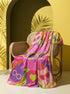 A rectangular velveteen minky blanket with a bright, retro pop art design. The top features a large, hot pink cat head wearing lime green sunglasses in the center. Swirling psychedelic background rays in vibrant orange, purple, and lime green radiate outward. Four smaller cat heads in peach, green, and purple, also wearing glasses, sit in the corners alongside retro flowers, stars, and a lime green heart. The reverse side is a fluffy off-white sherpa fleece.