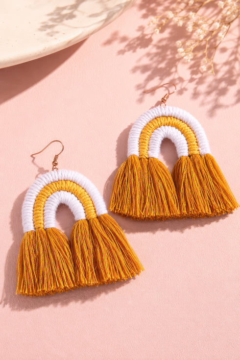 a pair of earrings with a yellow and white color scheme, with the earrings being the main focus.