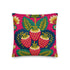 A square throw pillow with a vibrant, folk art-inspired design. The pillow's background is a bright, saturated fuchsia pink. The central design features four stylized strawberries arranged in a cluster, rendered in a way that mimics thick, textural embroidery. Each strawberry is red. The overall aesthetic is colorful, eclectic, and maximalist, with a distinct retro or 70s feel. The pillow cover has a visible linen-like texture.