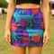 Honey Dazed tiger floral mini skirt in a neon jungle print with electric blue stripes, violet flowers, and lush tropical leaves. This fitted pencil silhouette is made with performance eco-polyester and hugs the body with a smooth, curve-enhancing stretch. High-waisted and fierce, this design channels wild energy, retro rave vibes, and maximalist jungle glam. A fearless standout piece for festival nights and bold daytime slayage.