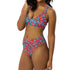 Vibrant two-piece leopard print swimsuit with abstract red and teal pattern. Sports bra-style top and high-waisted bottoms. Purple background. Tag visible. Trendy, colorful beachwear for modern style.
