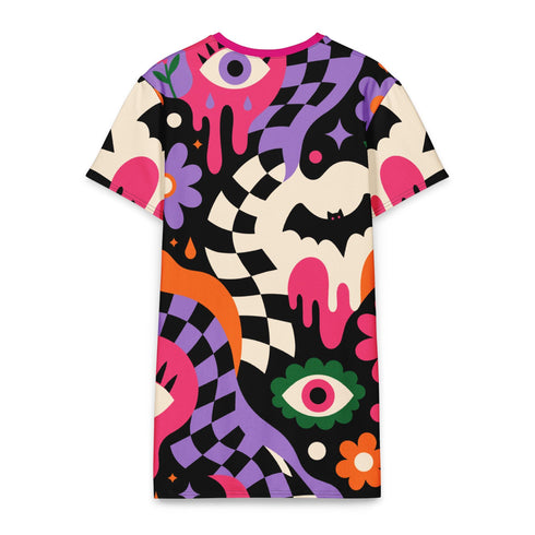 A short-sleeve, above-the-knee t-shirt dress with a relaxed, straight fit and a crew neckline. The dress features a vibrant, chaotic, all-over graphic print. The design includes sections of distorted, wavy black and cream checkerboard, mixed with bold, abstract shapes in bright purple, hot pink, and vivid orange. Scattered throughout the pattern are motifs of hot pink dripping slime, a black bat silhouette, a stylized green eye with a pink iris, and retro pink and purple daisy flowers.