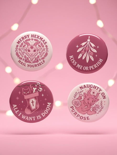 Set of 4 1.75 inch round pastel goth holiday pinback buttons. 1: Light pink with Baphomet head in wreath reading Merry Hexmas Hail Yourself. 2: Dark mauve with skull mistletoe reading Kiss Me or Perish. 3: Dark mauve with coffin stocking and black cat reading All I Want is Doom. 4: Light pink with cute Baphomet holding a sack reading Naughty on Purpose. All feature durable tinplate construction, high gloss laminate finish, and a secure metal safety pin back.