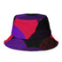 Reversible unisex bucket hat featuring two distinct geometric designs - one side showcases a bold abstract pattern with angular shapes in vibrant purple, pink, red, and black creating dynamic geometric forms and diamond-like structures, while the reverse side displays a contemporary abstract composition with curved organic shapes, linear textures, and color-blocking in purple, red, and black tones. Made from 100% polyester with textured linen feel, this moisture-wicking and breathable hat is available in XS