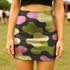 Honey Dazed bodycon mini skirt with abstract camo-inspired shapes in green, pink, black, and sage. The design mimics camouflage blobs with an amoeba-like twist in a high-waisted, stretchy silhouette. Made from eco-friendly performance fabric, this skirt is festival-ready, weirdcore-approved, and dance-floor durable. A subversive, soft-meets-tactical piece that blends retro rave energy with streetwear defiance.