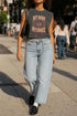 A garment dyed charcoal grey women's muscle tee featuring a slightly cropped boxy fit with structured shoulders and a wide rib collar. The front displays a retro 70s psychedelic graphic printed in purple, orange, and yellow. The text reads MY BODY MY CHOICE surrounding a central eye motif with a radial sunburst, framed by symmetrical mystical swirls and four point stars. The vintage style cotton shirt offers a faded aesthetic, presented on its own without background lifestyle elements.