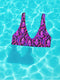 Psychedelic crystal bikini top featuring a vivid print of pink and purple crystals with wavy neon accents on a black background. Sports bra-style top with a scoop neckline, wide shoulder straps, and removable padding. Made of recycled polyester and LYCRA XTRALIFE with UPF 50+ sun protection. Available in sizes XS to 3XL. Double-layered construction with a snug, secure fit. Sustainable swimwear top for rave, beach, or summer festival wear.