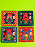 A set of four square coasters featuring a glossy glazed finish and vibrant insect illustrations. Each coaster measures approximately four by four inches. The designs showcase symmetrical beetles and spiders in bold red, blue, and orange colors, framed by intricate floral and geometric borders in a maximalist folk art style. Available in ceramic with cork backing or hardboard MDF. The edges are smooth. The designs are vivid and highly saturated, designed to provide grip and protect furniture.