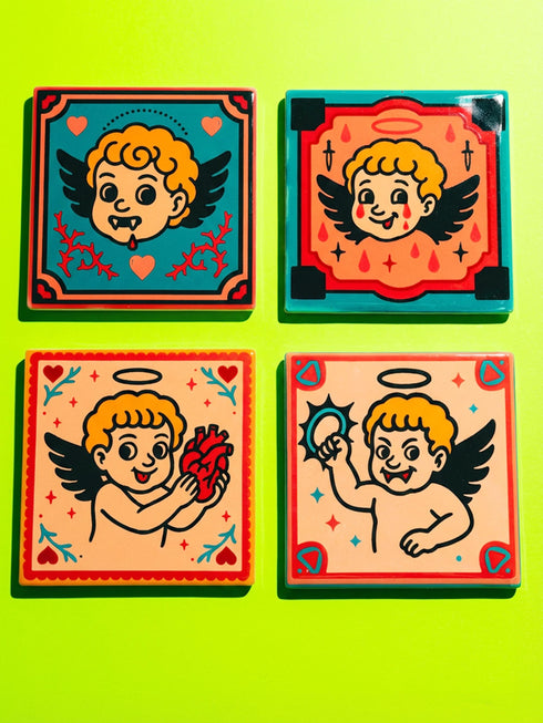 Set of four square ceramic coasters featuring a vampire cupid design in a pastel goth and traditional tattoo art style. The first coaster shows a fanged cherub on a teal background with red vines. The second features a cherub crying blood tears on a red background with daggers. The third depicts a cherub holding an anatomical heart on a peach background. The fourth shows a cherub with a spiked ring. Glossy glazed finish with cork backing. Ideal for spooky home decor and anti-valentine gifts.