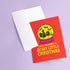 a red greeting card with a yellow snow globe design and the text "Have Yourself a Scary Little Christmas" printed on it.