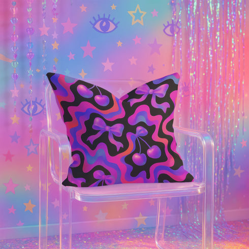 Throw pillow with a black background and a vibrant Y2K-inspired design featuring gradient cherries and shiny bows. The pattern includes pink, purple, orange, and blue psychedelic squiggles. The square pillow is displayed on a pink chair, bright blue couch, and outdoors with camping gear, emphasizing its bold, girly, and playful aesthetic. Perfect for dopamine decor, Gen Z bedrooms, or quirky home styling.