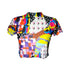 A colorful 90s-style mesh crop top featuring a maximalist abstract pattern. This see-through shirt has a high mock neck, short sleeves, and a vibrant, retro design with geometric shapes, color blocking, and polka dots in bold shades of pink, yellow, blue, and orange. The Y2K-inspired top is a statement piece of festival clothing, perfect for a rave outfit or alternative, dopamine-dressing-inspired streetwear looks.