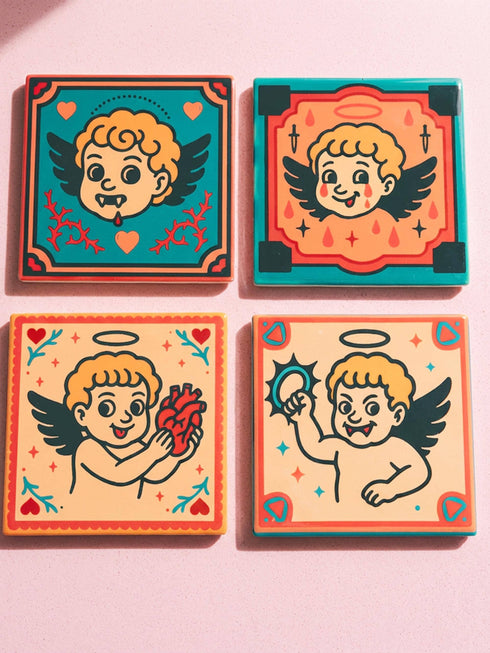 Set of four square ceramic coasters featuring a vampire cupid design in a pastel goth and traditional tattoo art style. The first coaster shows a fanged cherub on a teal background with red vines. The second features a cherub crying blood tears on a red background with daggers. The third depicts a cherub holding an anatomical heart on a peach background. The fourth shows a cherub with a spiked ring. Glossy glazed finish with cork backing. Ideal for spooky home decor and anti-valentine gifts.