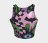 A close-up view of a sleeveless performance knit crop top featuring a vibrant pastel goth all-over print on a solid black background. The repeating pattern includes large black vampire bats flying over dripping, melted slime shapes in neon green. Wavy, warped checkerboard patterns in pastel pink, light purple, and black weave through the design. The graphic is finished with stylized, oversized pastel floral motifs and large open eyeballs staring outward.