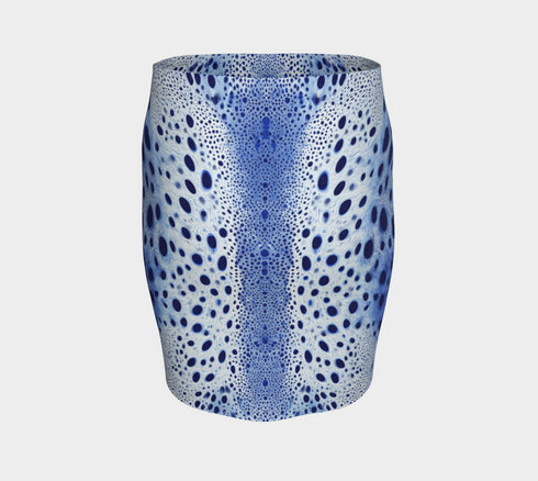 A high-waisted, bodycon mini skirt with a tight, fitted silhouette ending mid-thigh. The skirt features a vibrant, all-over graphic print inspired by a deer pelt. The pattern consists of a white and light blue textured base covered in irregular royal blue spots of varying sizes, creating a mesmerizing, psychedelic animal print effect. The skirt is made from a smooth, stretchy performance knit fabric with a subtle sheen, designed to hug the body's curves. The elastic waistband is seamless.