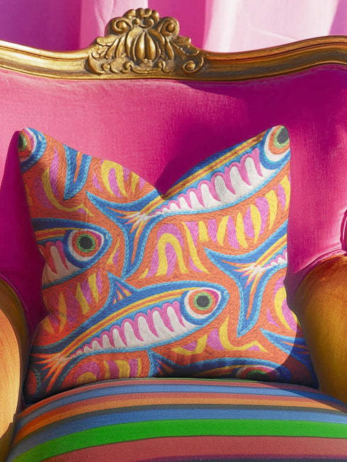 Flat printed square throw pillow cover featuring a faux embroidery texture. The vibrant maximalist design showcases stylized blue, pink, yellow, and white fish swimming in a dynamic, swirling pattern across a bright orange background. The artwork mimics heavy crewelwork yarn and stitching, but the material is a smooth 2D flat print. The pillow is shown as a finished square cover, designed to add bright, colorful eclectic fisherman aesthetic decor to any sofa or seating area.