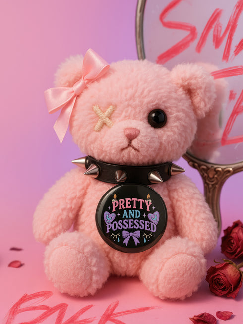 Glossy black pinback button with pastel-colored embroidered-style text that reads “Tell Me to Smile and I’ll Scream,” with lips icon and star accents.