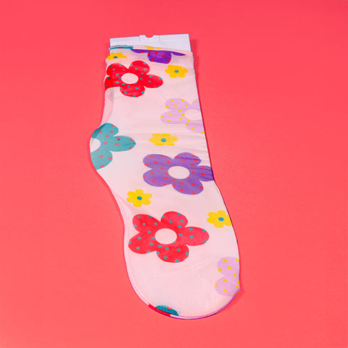 a white sock with flowers on it on a pink background