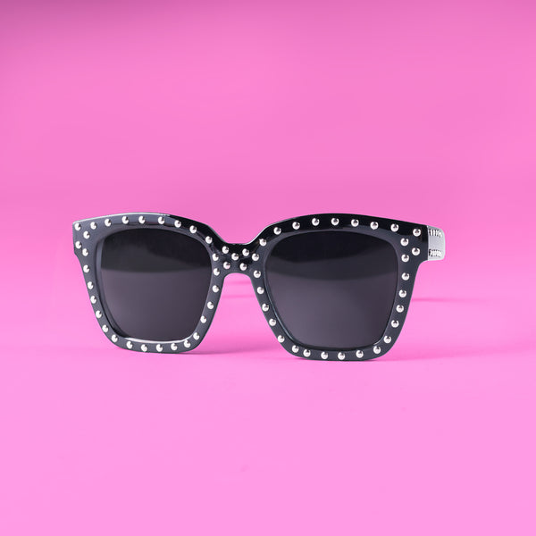 a pair of sunglasses on a pink background