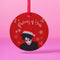 Round red metal Christmas ornament featuring Robert Smith silhouette in black with white Santa hat, red lips, and snowflake details. Text reads "Pictures of Yule" in white script.