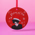 Round red metal Christmas ornament featuring Robert Smith silhouette in black with white Santa hat, red lips, and snowflake details. Text reads "Pictures of Yule" in white script.