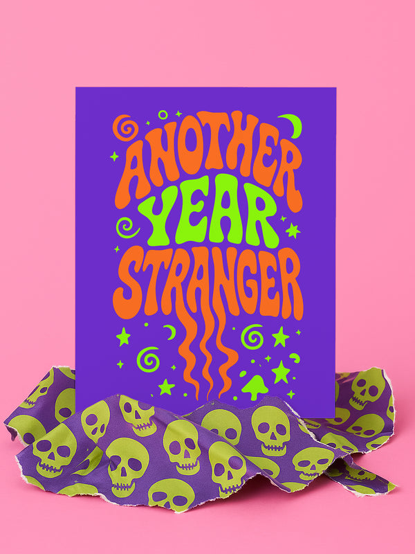 a vibrant purple background with the text "Another Year Stranger" in a stylized font, surrounded by orange and green swirls and stars.